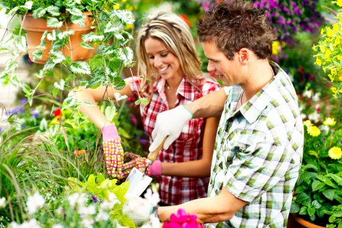 Community volunteers spreading compost in a local garden